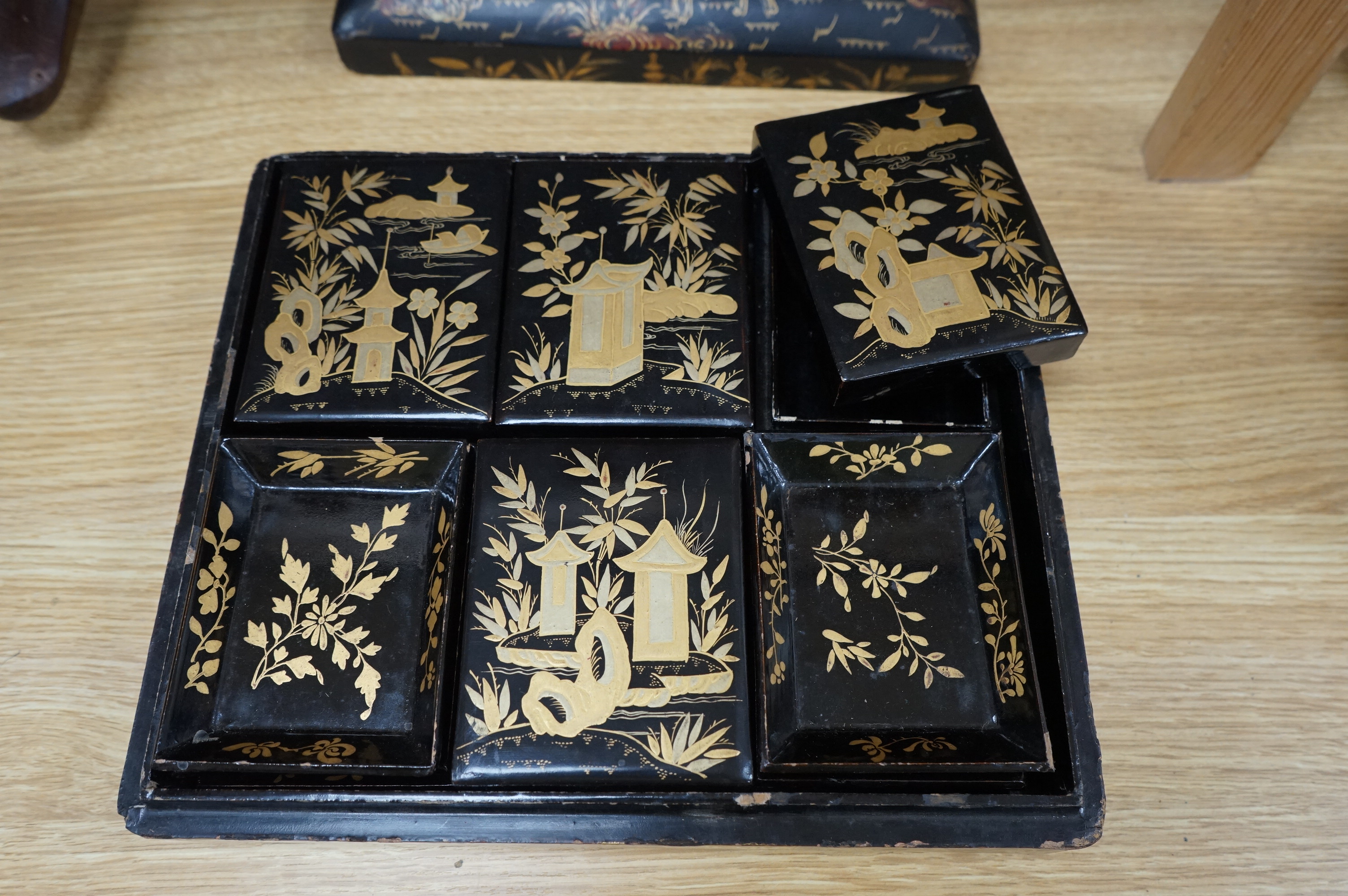 A mid 19th century Chinese gilt decorated black lacquer games box, 29cm wide x 25.5cm deep. Condition - some grazes and chips to lacquer